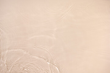 Transparent beige clear water surface texture with ripples, splashes. Abstract nature background...