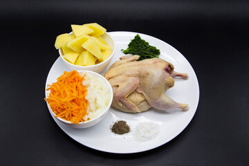 Fresh raw organic quail meat with ingredients for cooking healthy soup. Raw quail bird, fresh cut...