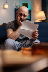 Sad disappointed man feeling worried about eviction notice warning, needing to pay mortgage taxes....