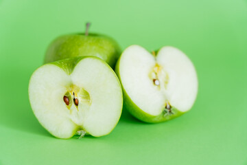 juicy and ripe apples on green background.