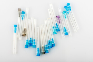 used medical syringes on a white background