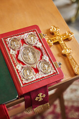 orthodox bible and cross on a stand for a priest