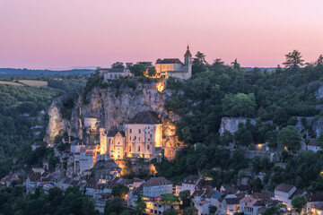 Twilight approaches Rocamadour and first warm  light from illumination appears on the sacred...
