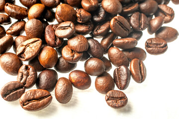 Close-up photo of coffee beans on a white background.shallow focus effect.