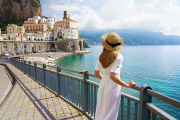 Holidays on Amalfi Coast. Back view of beautiful fashion girl enjoying view of Atrani village on Amalfi Coast. Summer vacation in Italy. - obrazy, fototapety, plakaty