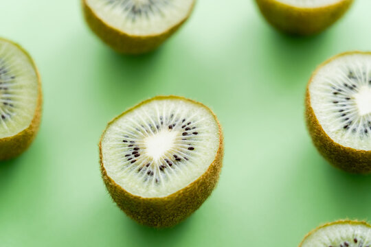 close up view of juicy fresh kiwi fruit on green.