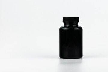 Unbranded black plastic bottle for cosmetics products. Skincare and cosmetology mockup. Branding identity template for text and design