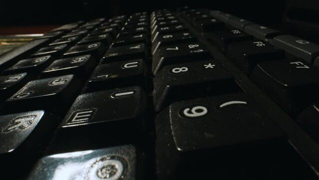 Camera flyover over a black Russian-English keyboard.