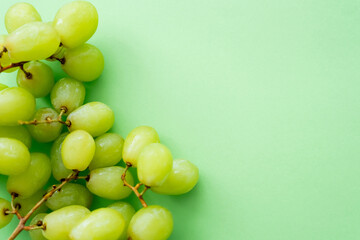 top view of ripe and organic grapes on green.