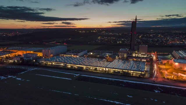 Silo tower in industrial zone while sunset aerial time lapse