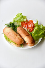 Hot dogs with sausage with herbs and tomatoes