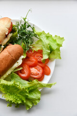 Hot dogs with sausage with herbs and tomatoes