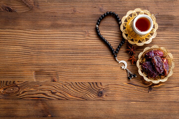 Islamic rosary with dates and tea. Ramadan Kareem concept.