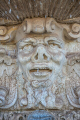 Ancient sculpture of funny, tricky and joyful dickens at fountains in historical downtown of...