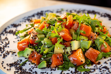 salad with salmon avocado arugula and black sesame