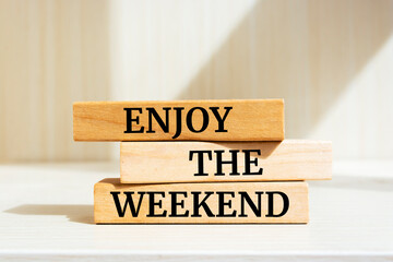 Wooden blocks with words 'Enjoy the weekend'.