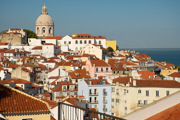 Fototapeta na wymiar Views of the Alfama district in Lisbon from nearby lookout points, a combination of red-roofed buildings.