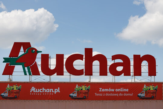 Poznan, Poland. April 2, 2022: Logo or symbol of Auchan in Poznan Planet Retail Park. Auchan is French network.