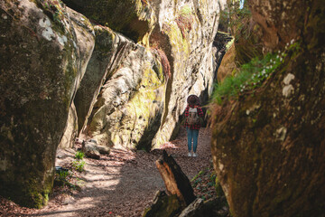 woman hiker with backpack walking by trail