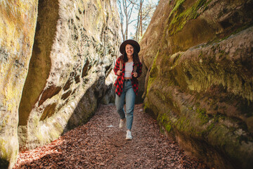 woman hiker with backpack walking by trail