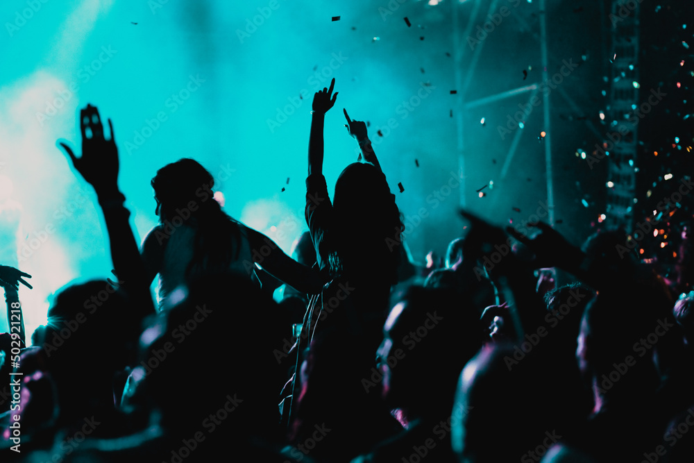 Wall mural cheering crowd with raised hands at concert - music festival