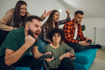 Group of friends playing video games at home