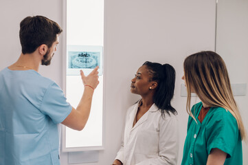 Group of doctors looking at x-ray image from jaw