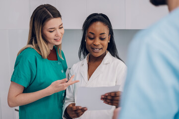 Multiracial team of doctors discussing a patients condition while working in a hospital
