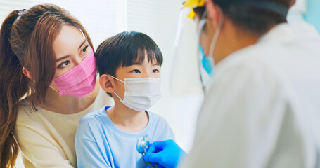 pediatrician examining sick boy