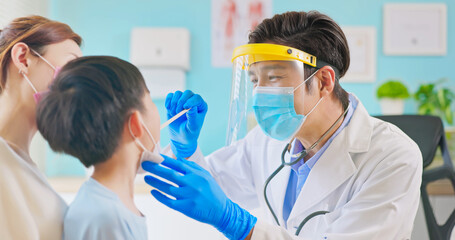 pediatrician examining sick boy