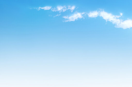 Blue sky with white fluffy cloud, soft focus. Heavenly cloud background, summer. Concept of freedom, relaxation, ecology. Copy space.