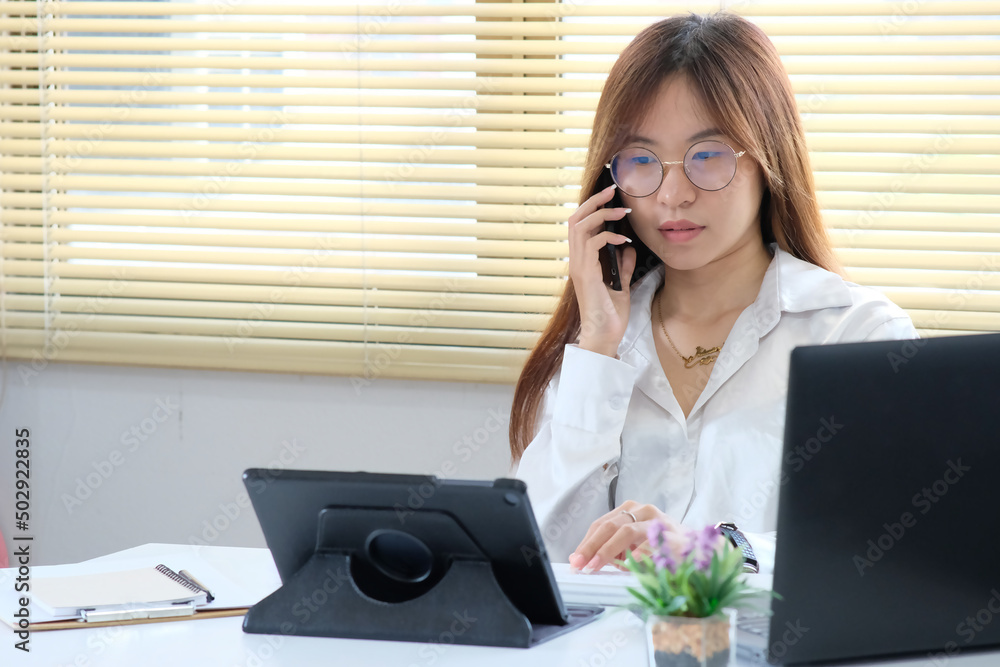 Poster woman is utilizing a laptop computer. using a smartphone, online live chat chatting on an applicatio