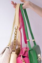woman hand holding set of colorful bags. Product composition photography. handbag and purse for women