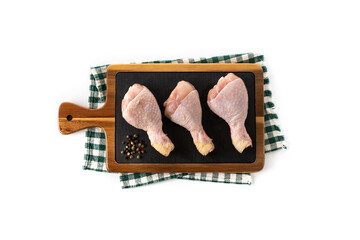 Raw chicken meat legs on cutting board isolated on white background. Top view