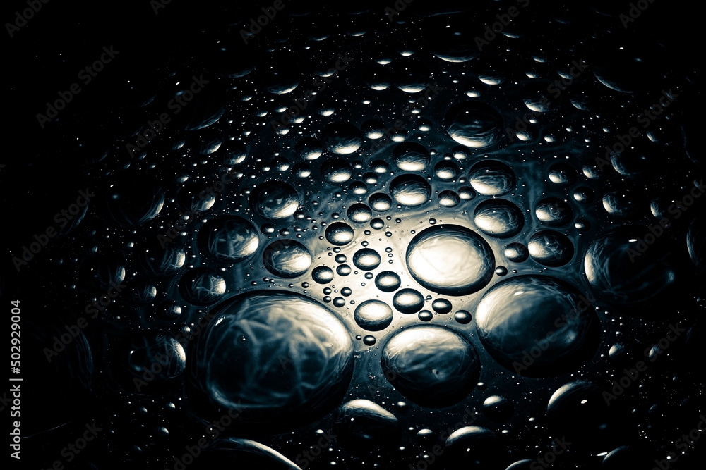 Wall mural abstract dark shiny background with droplets. droplets background with a dim spotlight.