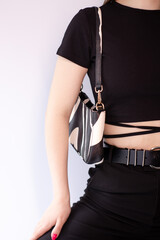 close up of womans hand holding fashionable little black bag. Product photography. stylish handbag and purse for women