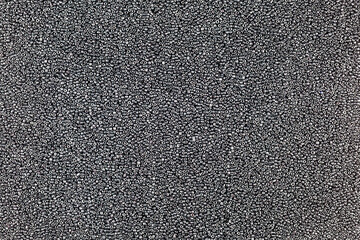 The background is formed by a lot of black beads, similar to black caviar.