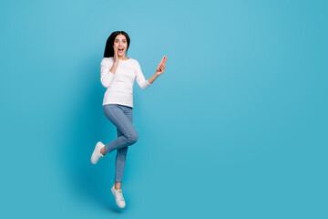 Fototapeta na wymiar Full length body size view of beautiful trendy amazed girly girl jumping using gadget app isolated on bright blue color background