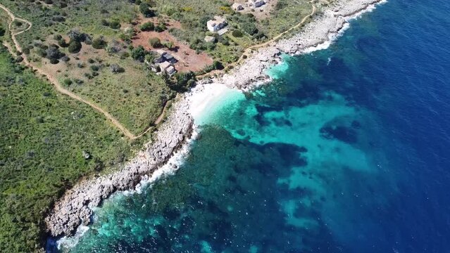 top view of a beautiful white sandy bay with crystal clear turquoise water (zingaro on the island of sicily in italy), very nice and sunny weather