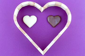The heart is made of wood, inside of this heart are two small hearts of white and brown. Valentine's Day theme.