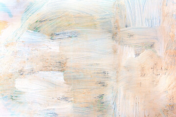 Brush strokes with light beige paint on the wall as a background, texture, pattern.