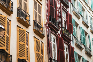 Fototapeta na wymiar Colorful windows in the city, yellow, red, green, blue haus windows, minimal city view