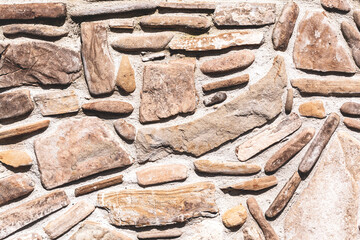 The surface is lined with brown stones of different shapes as a background, texture, pattern.