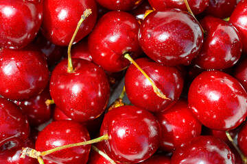 Lots of fresh, ripe red cherries as background, texture, pattern.