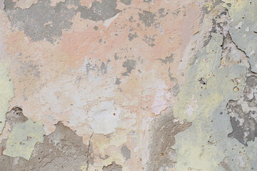 Old flaky wall with destroyed plaster. Renovation of old house. Industrial style design wall background. Grunge cracked concrete wall with old paint. Shabby peeling old background