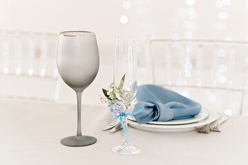 Table setting for holidays and wedding, blue color. A set table for a celebration, event, party or wedding in an outdoor restaurant. Soft selective focus.