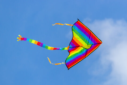 Kite in LGBT colors on a background of blue sky.