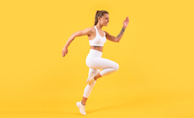 Fototapeta na wymiar fitness girl runner running on yellow background