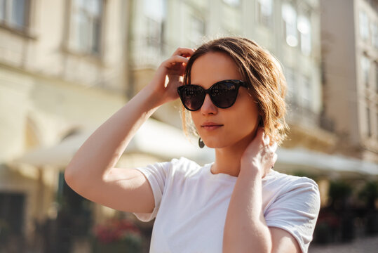 Portrait of young woman in sunglasses and white t-shirt