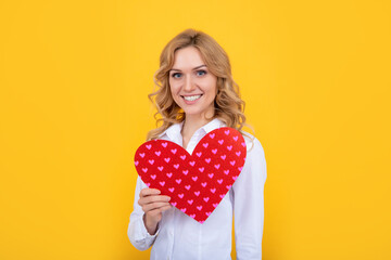 smiling woman with red love heart on yellow background
